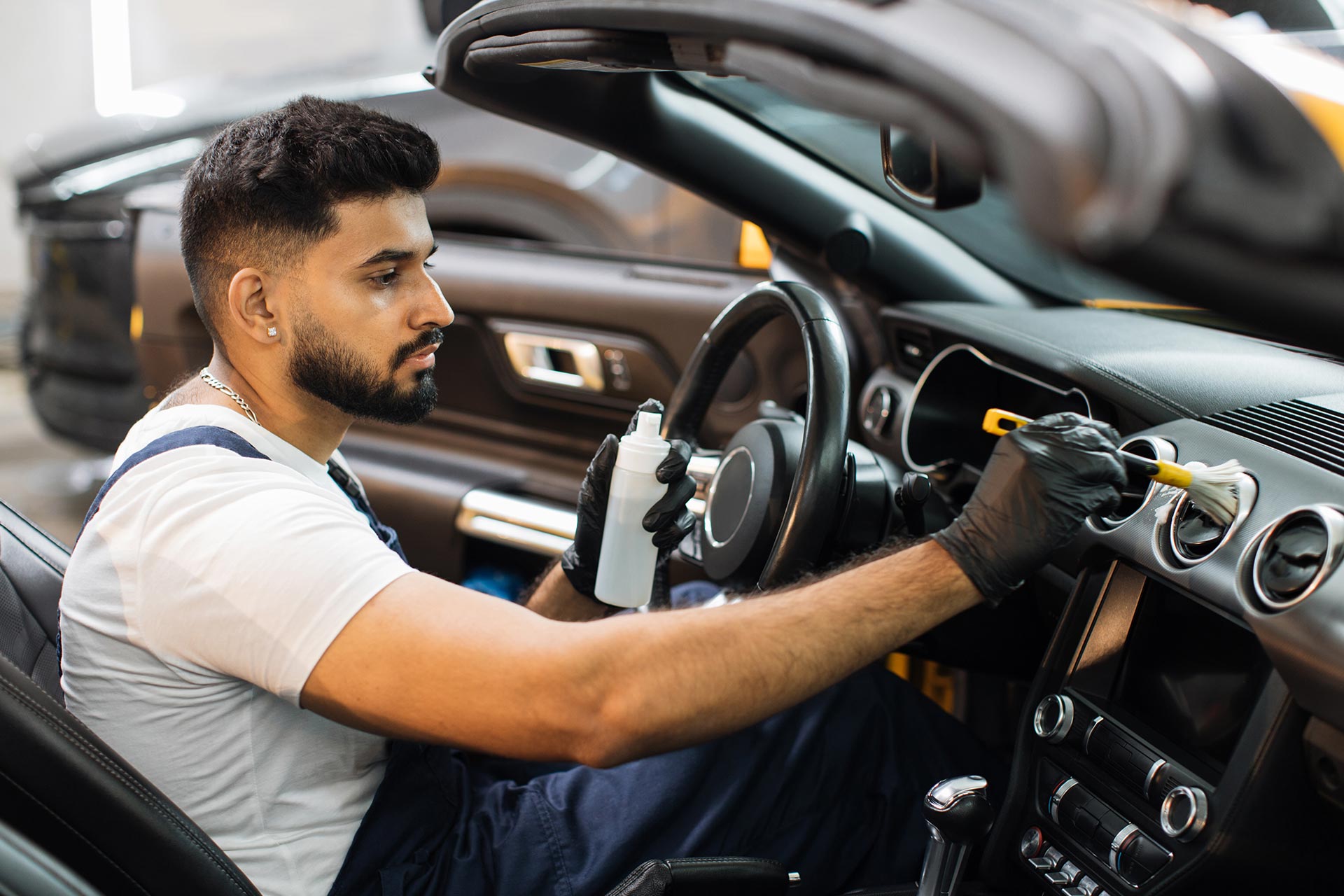 Mechanic cleaning the inside of a car