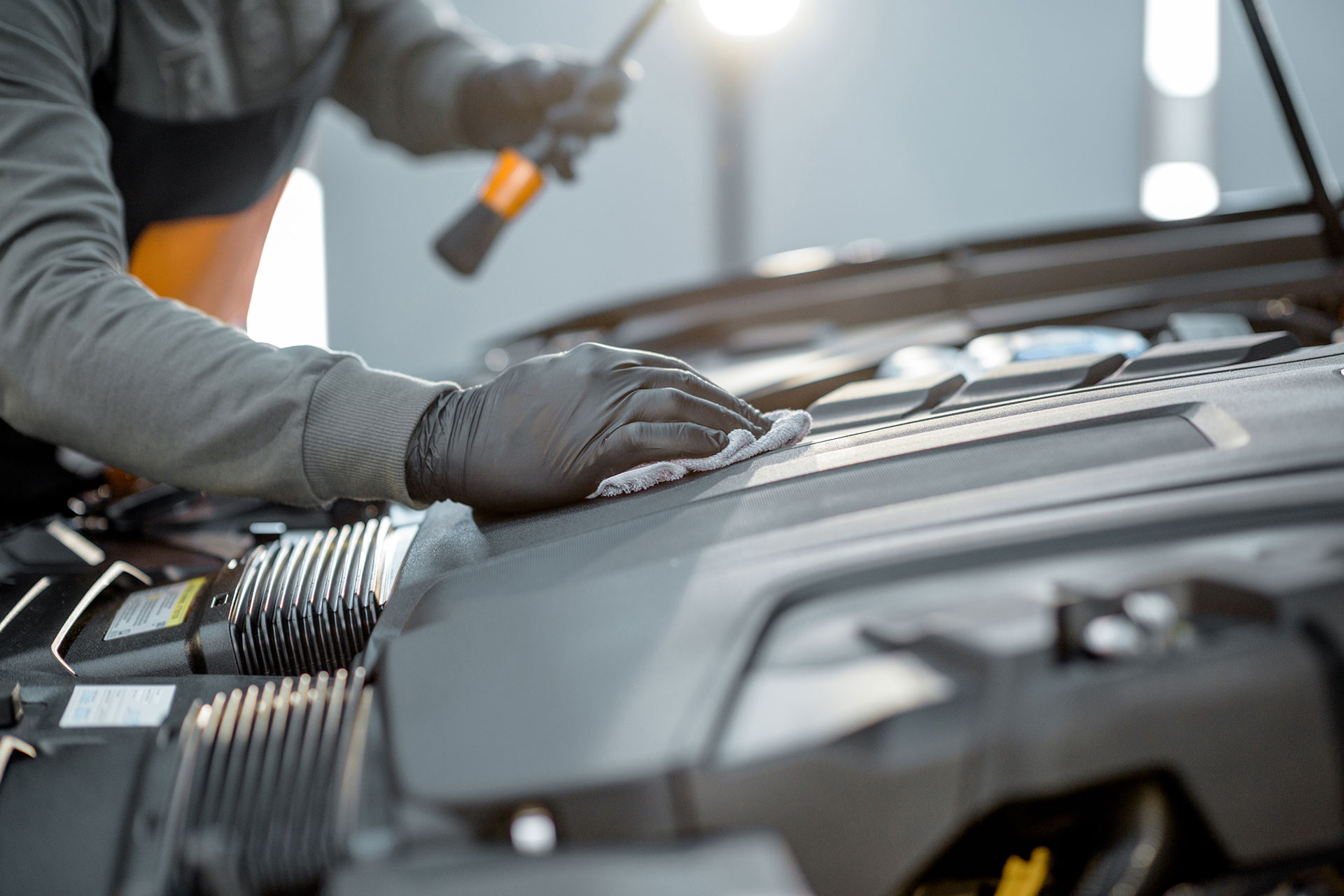 Mechanic working under a car hood